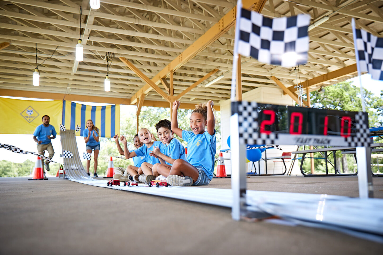 Cub Scouts racing cars on a Pinewood Derby track