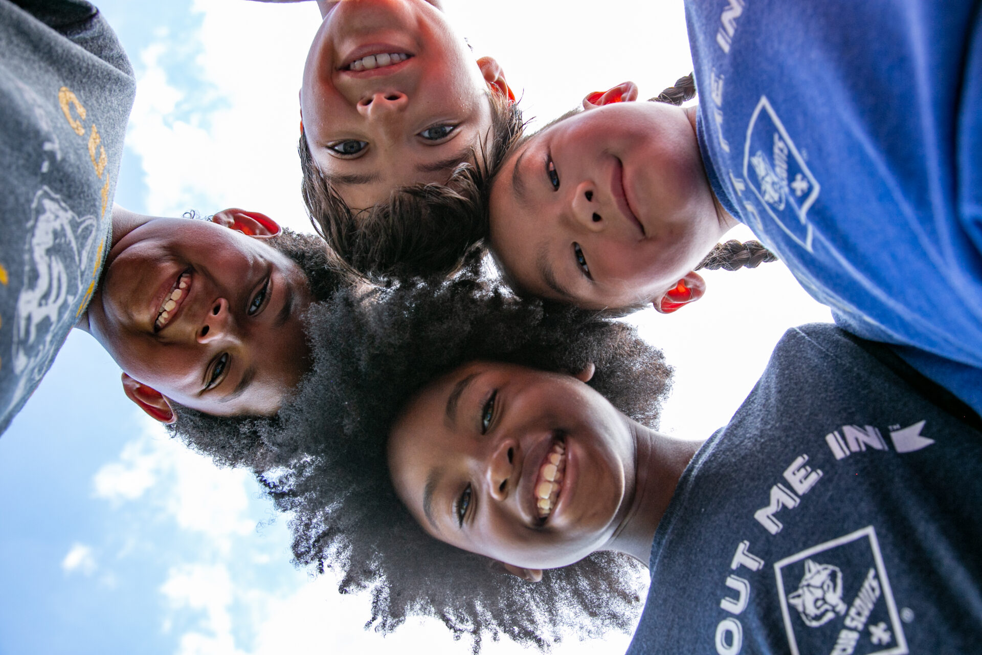 Selfie shot from below of kids at a den meeting